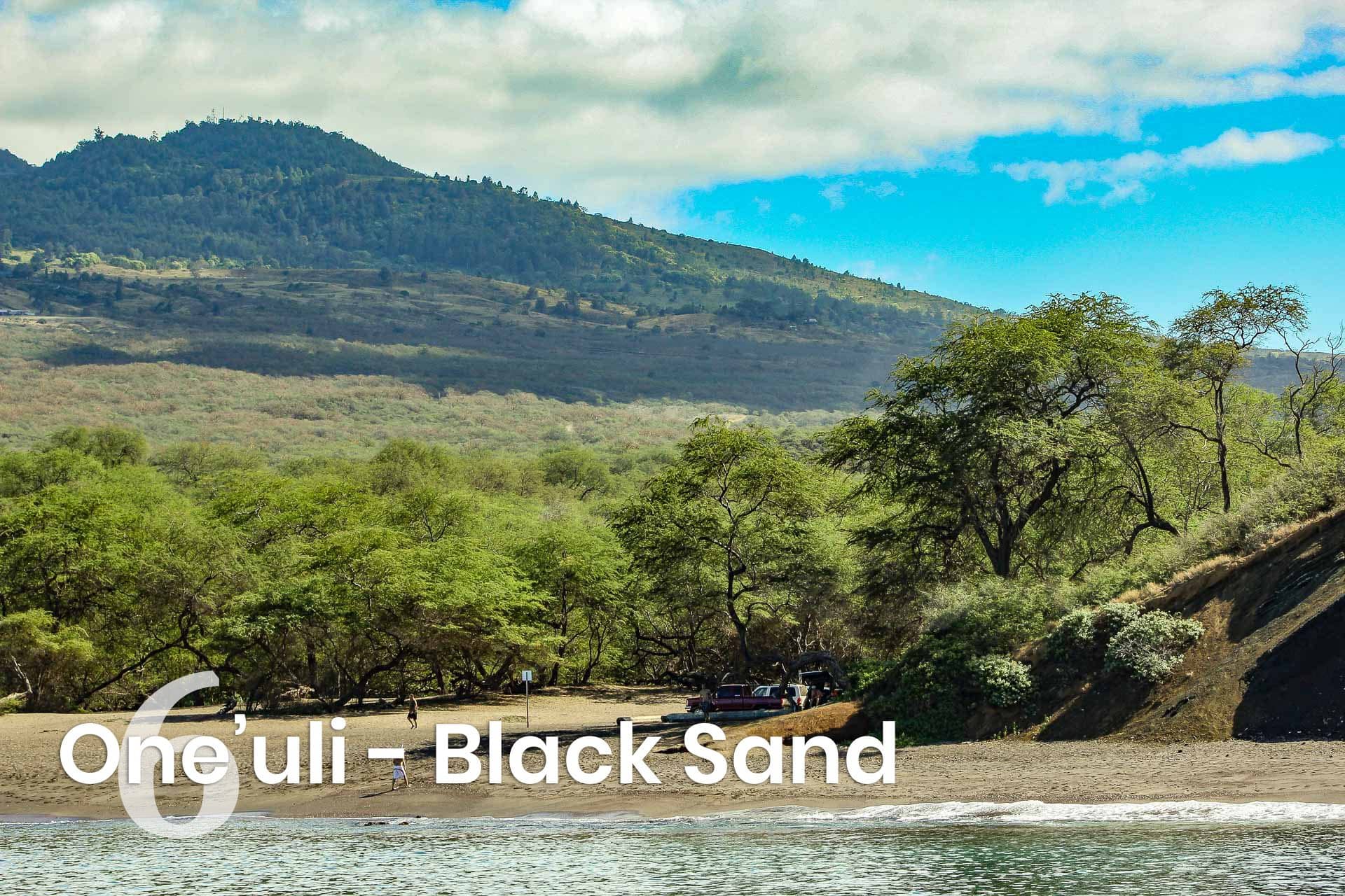 text that says One'uli - black sand with a picture of the beach in the background